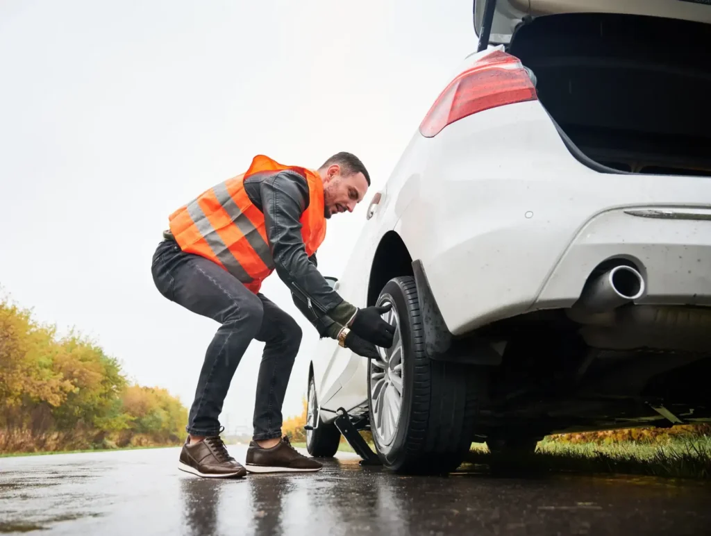 Towing company is changing a tire on a vehicle, providing essential roadside assistance